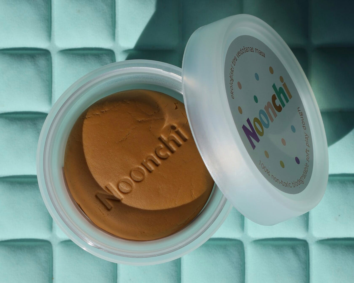 Organic modeling clay in rich ochre brown – safe, biodegradable dough perfect for crafting diverse characters with darker complexions.