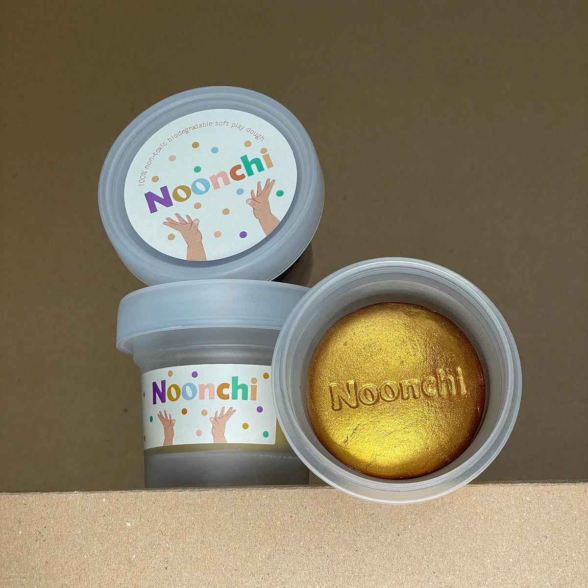 Cup of organic golden play dough with biodegradable glitter – non-toxic, eco-friendly, and safe for kids, perfect for creative play.